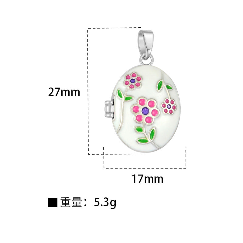 Assorted oval enamel photo locket pendants with hand-painted pastel flower designs in pink, blue, yellow, purple, and white.