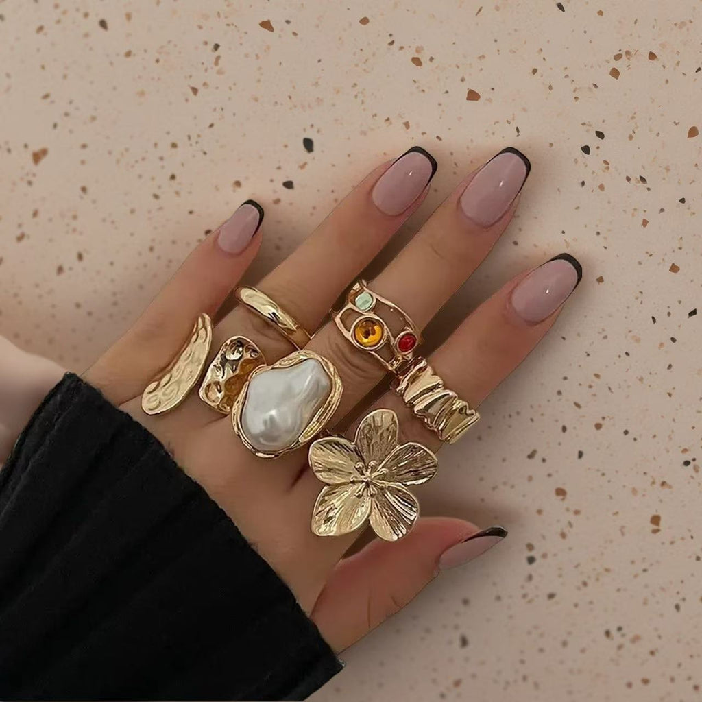 Textured open cuff flower motif, baroque pearl accent, and hammered gold bands 6 piece adjustable stackable ring set stainless steel jewelry in waterproof 18k gold plated finish.