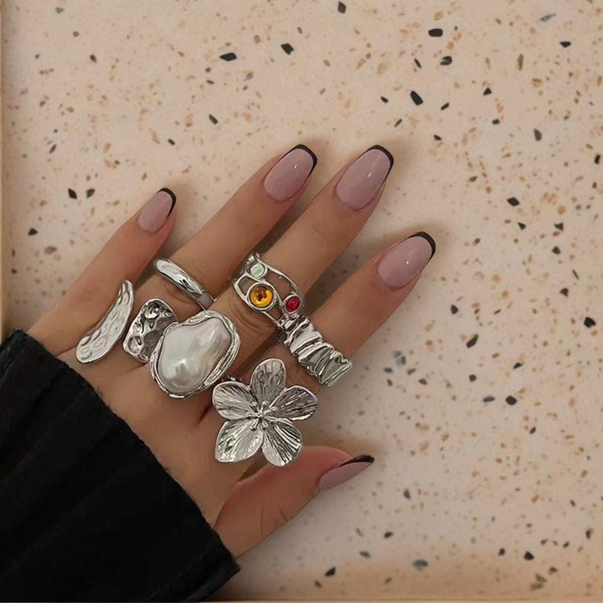 Textured open cuff flower motif, baroque pearl accent, and hammered gold bands 6 piece adjustable stackable ring set stainless steel jewelry in waterproof 18k gold plated finish.