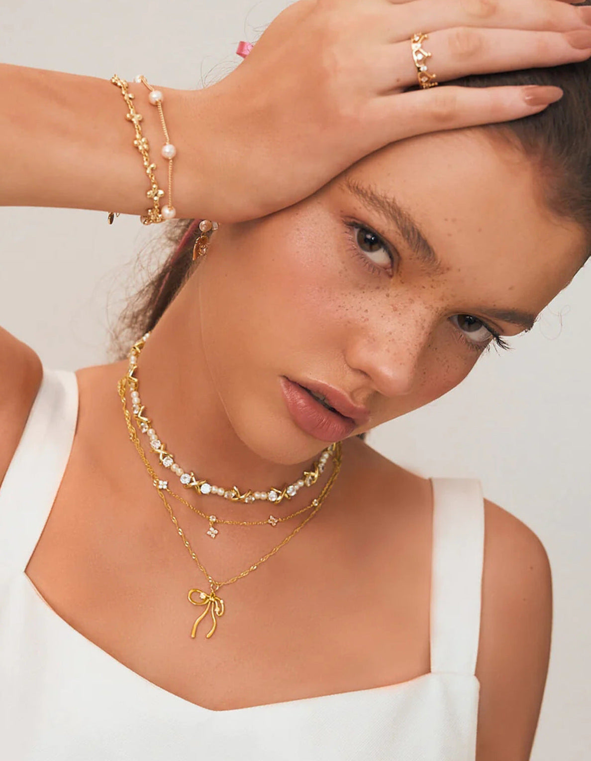 Fluid ribbon bow pendant Singapore twist chain necklace with sparkling crystal accents in 18k gold plated jewelry.