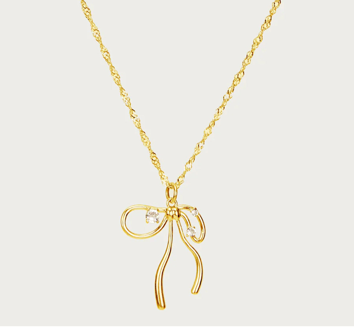 Fluid ribbon bow pendant Singapore twist chain necklace with sparkling crystal accents in 18k gold plated jewelry.