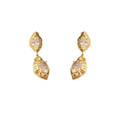 A pair of geometric drop earrings with a hammered gold texture and brilliant oval zircon accents