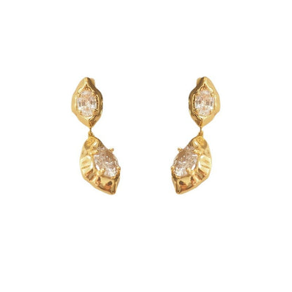 A pair of geometric drop earrings with a hammered gold texture and brilliant oval zircon accents