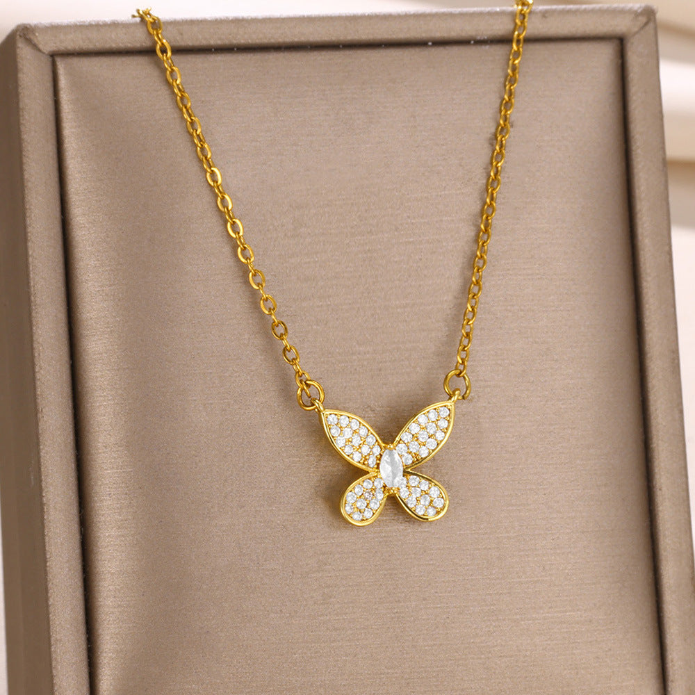 Elegant gold bow pendant necklace featuring a dainty butterfly ribbon design adorned with sparkling zircon accents