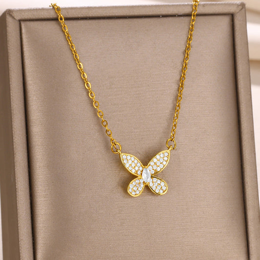 Elegant gold bow pendant necklace featuring a dainty butterfly ribbon design adorned with sparkling zircon accents