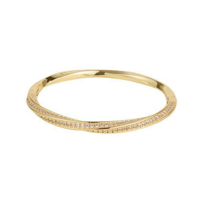 Modern gold bypass wrap bangle featuring dual round halo charms with sparkling white cubic zirconia