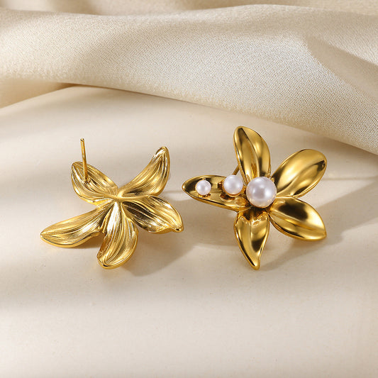 Paired gold flower stud earrings featuring a central white pearl in an elegant blooming petal design