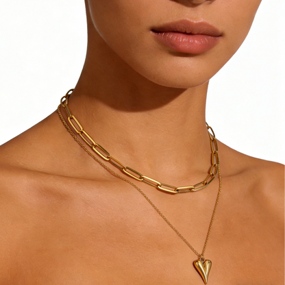 Elegant gold double-layer necklace featuring a minimalist heart pendant on a chic layered delicate chain