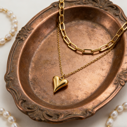 Elegant gold double-layer necklace featuring a minimalist heart pendant on a chic layered delicate chain