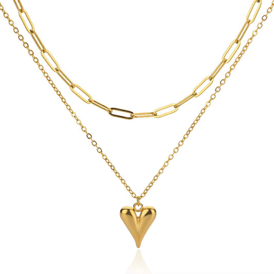 Elegant gold double-layer necklace featuring a minimalist heart pendant on a chic layered delicate chain
