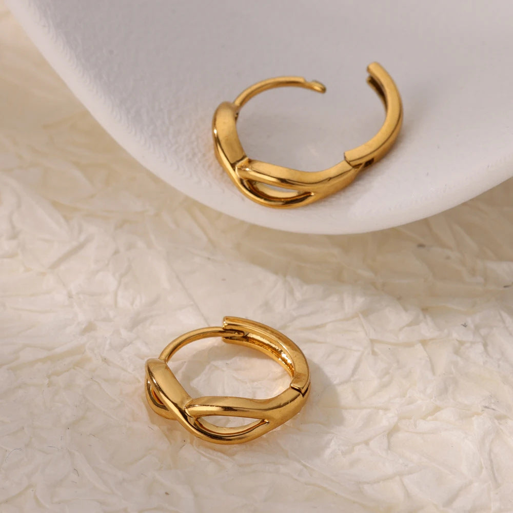 Paired minimalist gold stud earrings featuring a polished infinity symbol design for an elegant, timeless look