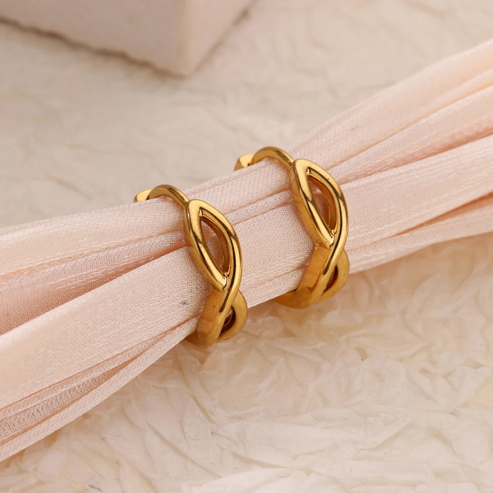 Paired minimalist gold stud earrings featuring a polished infinity symbol design for an elegant, timeless look