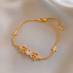 Elegant gold bracelet featuring a delicate iris flower charm paved with sparkling white cubic zirconia