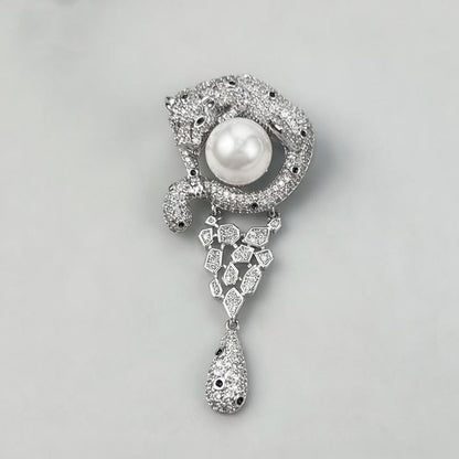 Luxurious gold leopard brooch with sparkling white zirconia and a large central pearl in a wild animal design