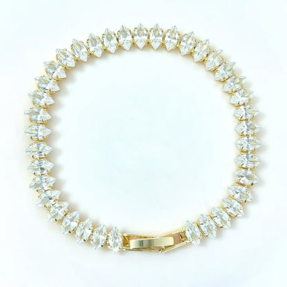 Elegant gold tennis bracelet featuring marquise-cut white cubic zirconia stones in a leaf-style continuous link