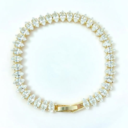 Elegant gold tennis bracelet featuring marquise-cut white cubic zirconia stones in a leaf-style continuous link