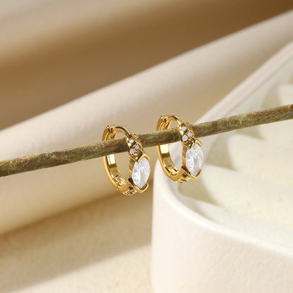 Elegant paired gold huggie hoop earrings with continuous clear zirconia and a central marquise-cut stone