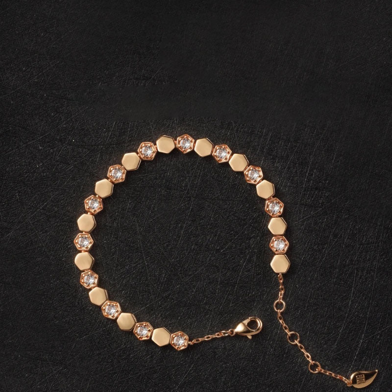 Modern gold bracelet featuring a geometric honeycomb design paved with brilliant moissanite stones