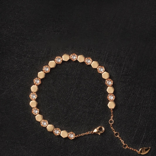 Modern gold bracelet featuring a geometric honeycomb design paved with brilliant moissanite stones