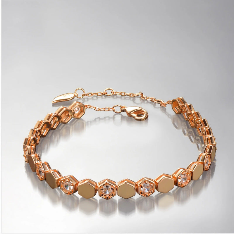 Modern gold bracelet featuring a geometric honeycomb design paved with brilliant moissanite stones