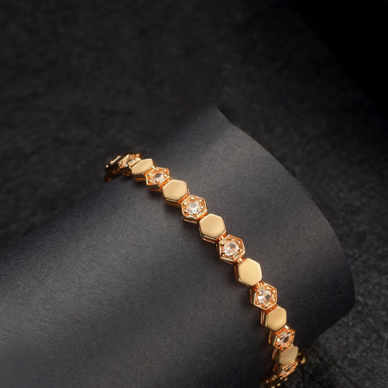 Modern gold bracelet featuring a geometric honeycomb design paved with brilliant moissanite stones