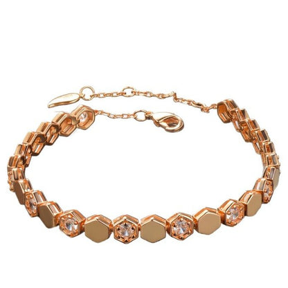 Modern gold bracelet featuring a geometric honeycomb design paved with brilliant moissanite stones