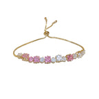 Sparkling gold tennis bracelet featuring multi-color and pink cubic zirconia in a continuous link design