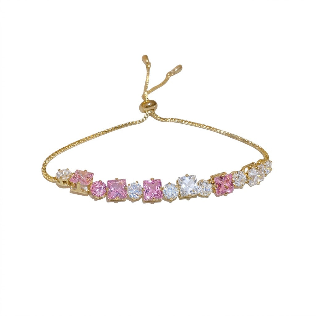 Sparkling gold tennis bracelet featuring multi-color and pink cubic zirconia in a continuous link design