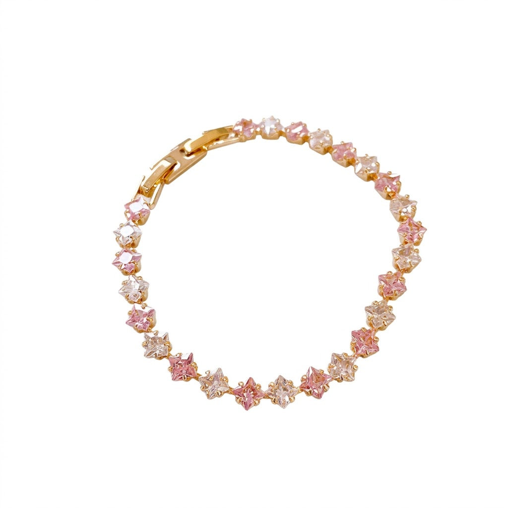 Classic gold tennis bracelet featuring a continuous line of sparkling pink cubic zirconia stones