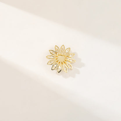 Charming gold plated daisy brooch featuring white cubic zirconia petals and a bright yellow stamen center