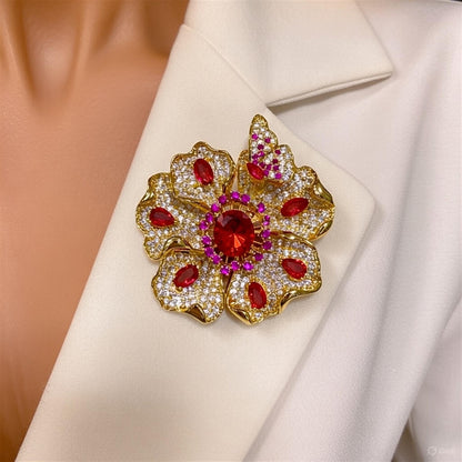 Elegant gold plated double-petal flower brooch featuring sparkling white cubic zirconia in a blooming design