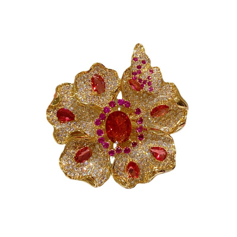 Elegant gold plated double-petal flower brooch featuring sparkling white cubic zirconia in a blooming design