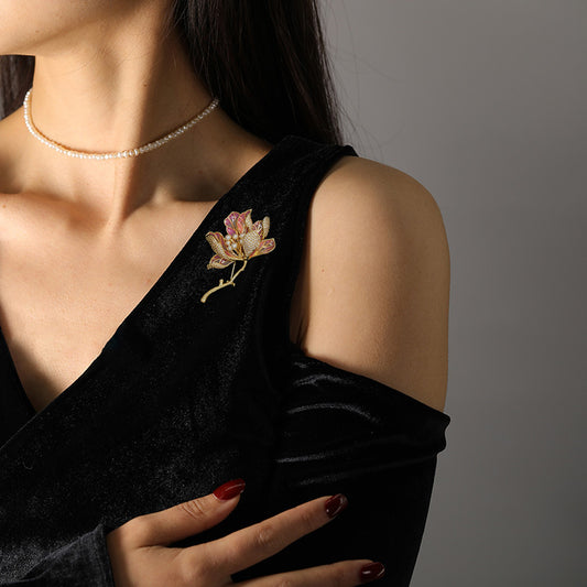 Elegant gold kapok flower brooch with pink and white zirconia petals and a central pearl accent