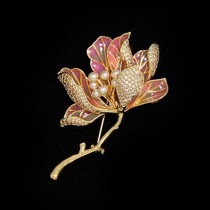 Elegant gold kapok flower brooch with pink and white zirconia petals and a central pearl accent