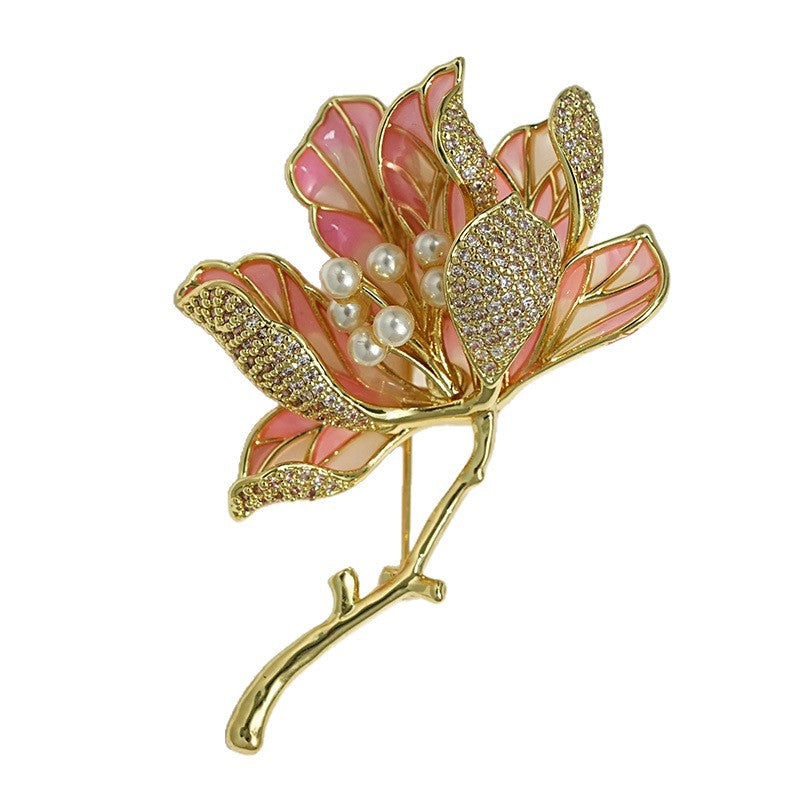 Elegant gold kapok flower brooch with pink and white zirconia petals and a central pearl accent