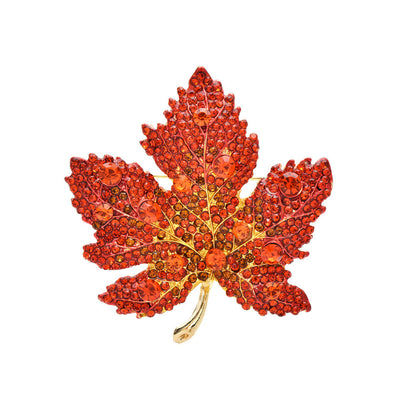 Elegant gold plated maple leaf brooch featuring gradient red cubic zirconia stones in a seasonal autumn design