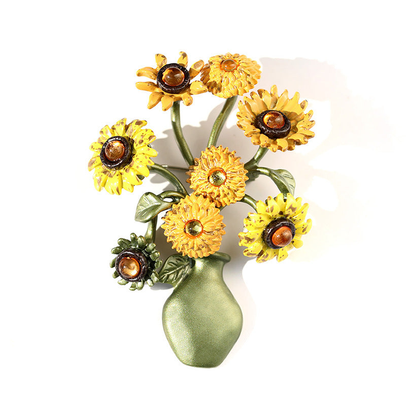 Vintage-style gold-plated sunflower brooch featuring vibrant yellow enamel petals and a textured floral design