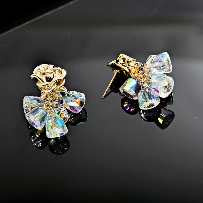 Gold dangle earrings featuring a delicate rose flower top and an intricate hollow bell charm for a vintage look