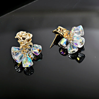 Gold dangle earrings featuring a delicate rose flower top and an intricate hollow bell charm for a vintage look