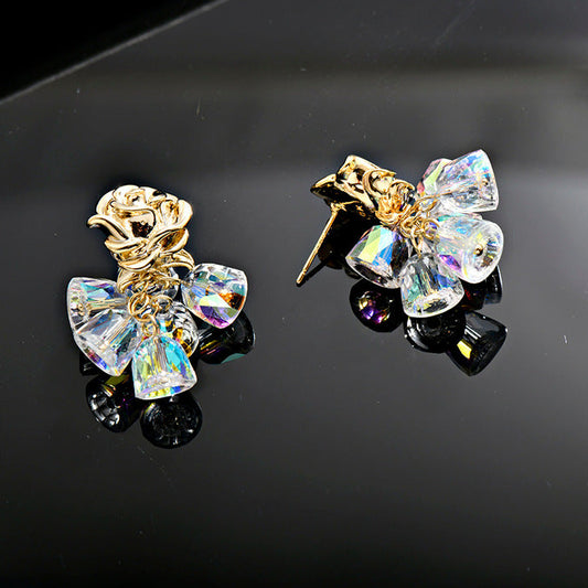 Gold dangle earrings featuring a delicate rose flower top and an intricate hollow bell charm for a vintage look