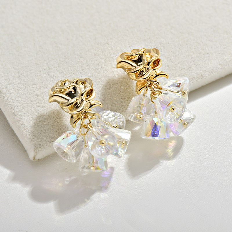 Gold dangle earrings featuring a delicate rose flower top and an intricate hollow bell charm for a vintage look