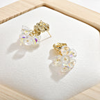 Gold dangle earrings featuring a delicate rose flower top and an intricate hollow bell charm for a vintage look