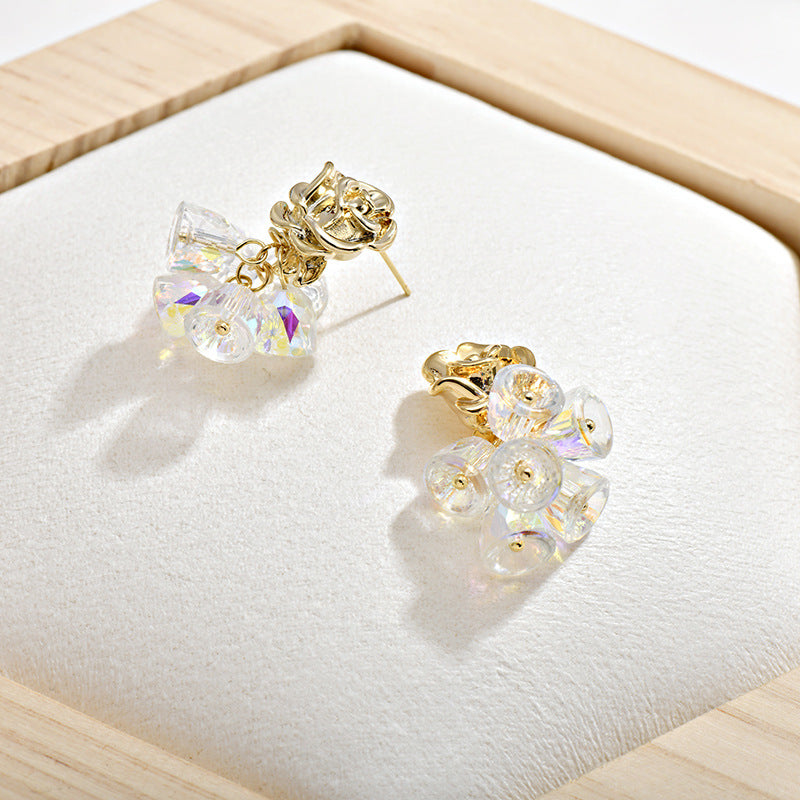 Gold dangle earrings featuring a delicate rose flower top and an intricate hollow bell charm for a vintage look