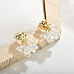Gold dangle earrings featuring a delicate rose flower top and an intricate hollow bell charm for a vintage look