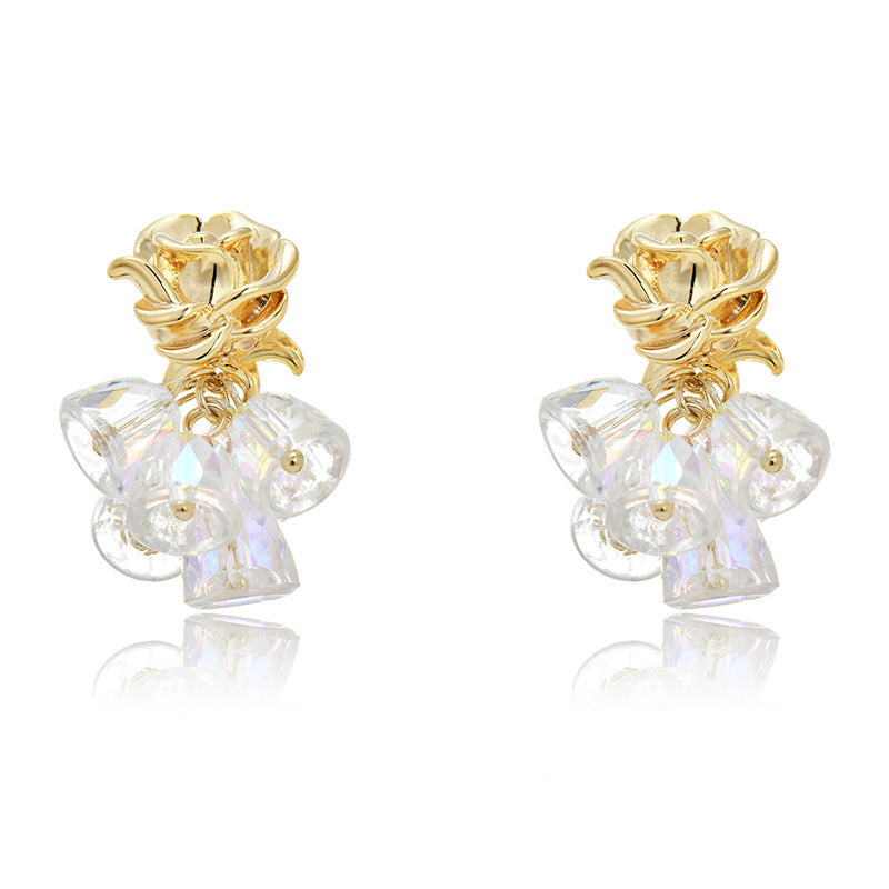 Gold dangle earrings featuring a delicate rose flower top and an intricate hollow bell charm for a vintage look