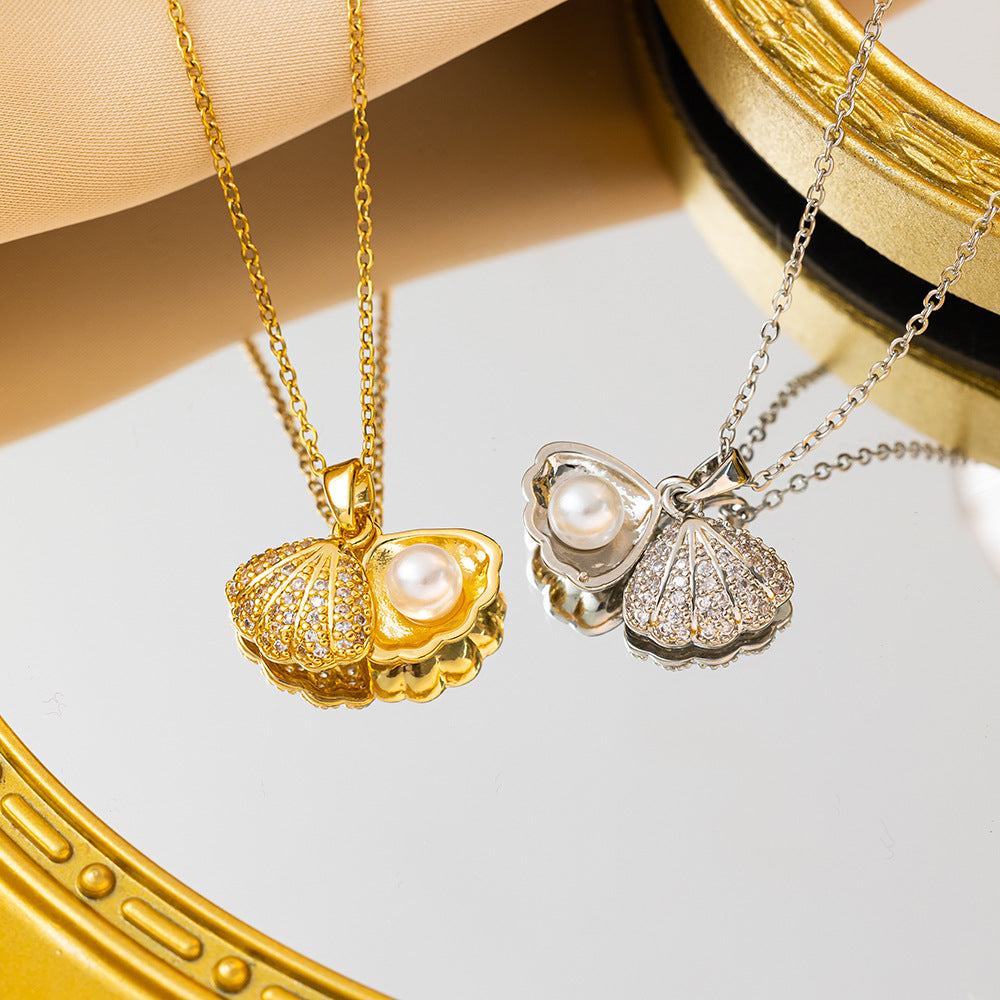 Elegant gold necklace featuring a shell-shaped pendant with a central pearl and shimmering zircon stones on the outer rim