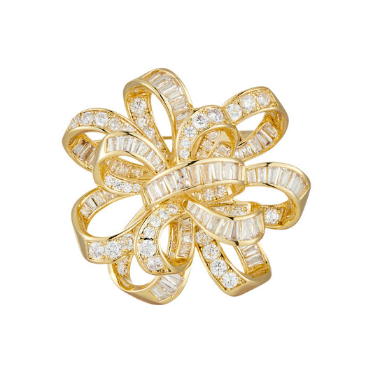 Dainty bowknot brooch with white cubic zirconia ribbon design, available in gold and silver plated finishes