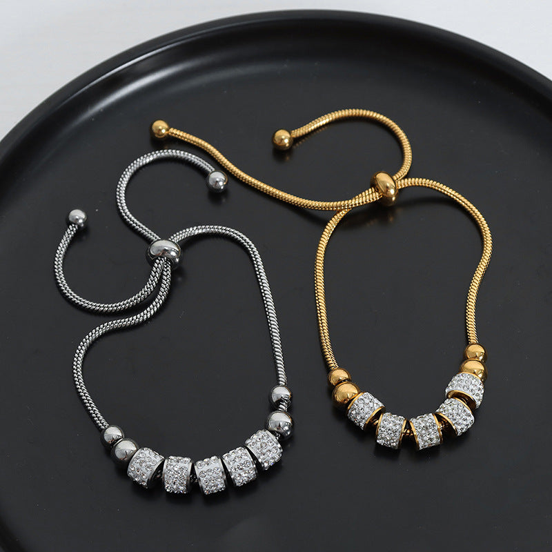 Chic cylindrical bead bracelet featuring a sparkling zirconia halo, available in gold and silver plated finishes