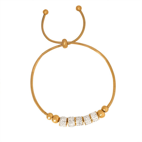 Chic cylindrical bead bracelet featuring a sparkling zirconia halo, available in gold and silver plated finishes