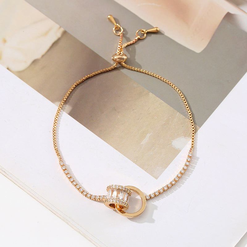 Chic double-layered bracelet featuring cubic zirconia charms, available in gold and silver plated finishes